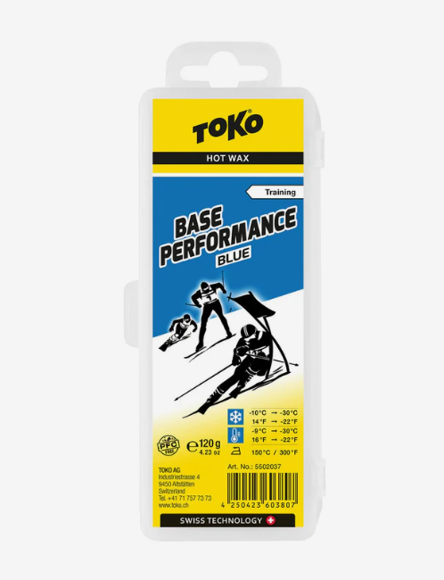 Toko Base Performance Blue Hot Wax in a clear plastic 120g case with a yellow and blue label featuring skiers.