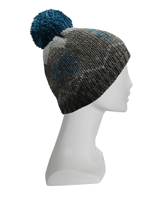 XTM Odin Beanie in grey and charcoal chunky knit with blue snowflake patterns and a large blue pom-pom on a mannequin.